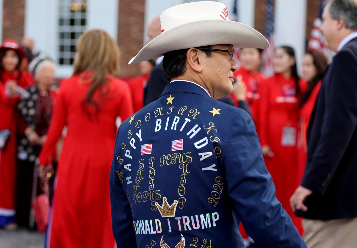 A guest wears a jacket with a birthday message for former president Donald Trump (Getty Images)