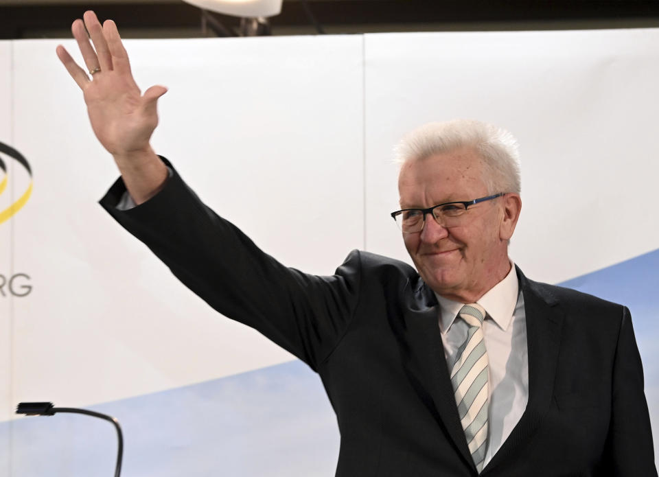 Winfried Kretschmann, Minister President of Baden-Wuerttemberg and top candidate of the Green Party, waves after the announcement of the first results of the state elections in Baden-Wuerttemberg in Stuttgart, Germany, March 14, 2021. Exit polls are pointing to defeats for Chancellor Angela Merkel’s center-right party CDU in two German state elections. (Uli Deck/dpa via AP)