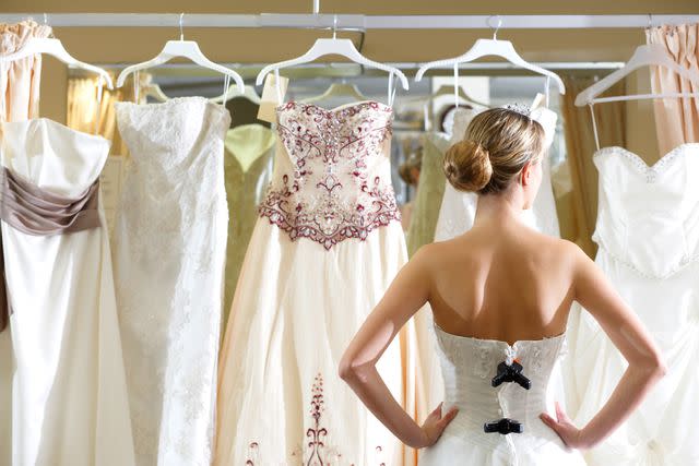 <p>Getty</p> Stock image of a bride trying on dresses