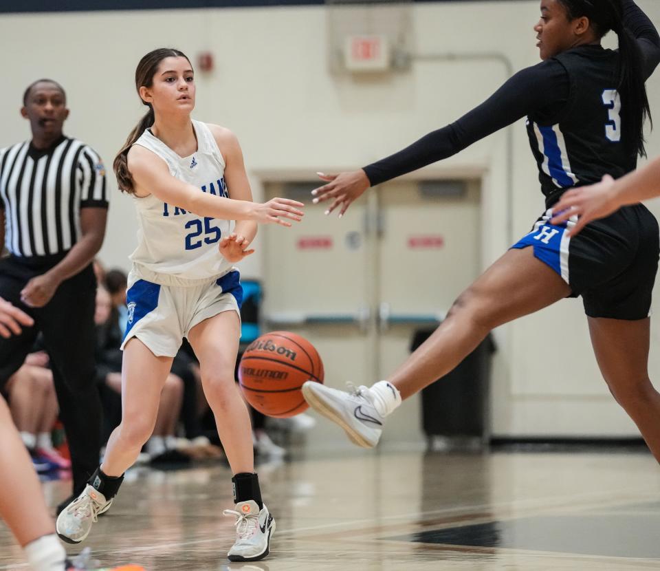 Bishop Chatard Trojans guard Betsy Tragesser (25) passes the ball Thursday, Jan. 11, 2024, during the City Tournament semifinals at Cathedral High School in Indianapolis. The Bishop Chatard Trojans defeated Heritage Christian, 56-45.