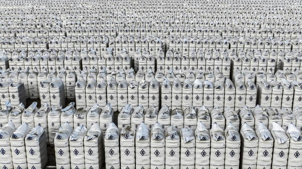 J.G. Boswell cotton bales are stored in neat rows on a large lot in Corcoran.