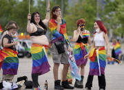 Football supporters are seen with LGBT pride flags outside of the stadium before the Euro 2020 soccer championship group F match between Germany and Hungary at the Allianz Arena in Munich, Germany,Wednesday, June 23, 2021. (AP Photo/Matthias Schrader)