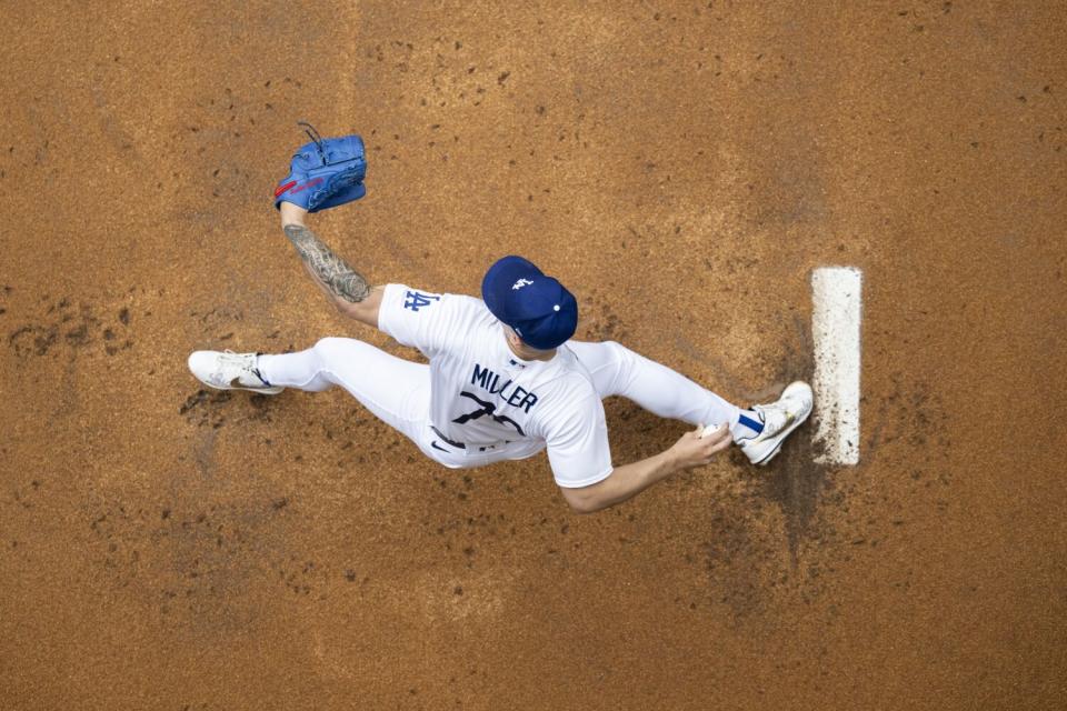 Dodgers starting pitcher Bobby Miller warms up in the bullpen.