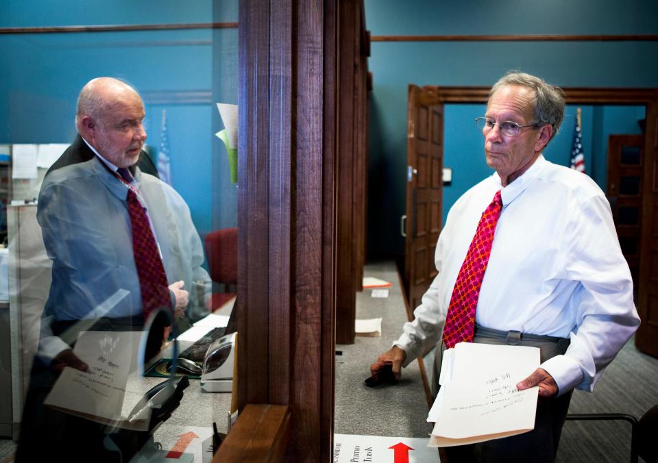 July 16, 2015 - Richard Holden (left), Administrator of Elections, talks to twice-convicted former elected official Joe Cooper after he files a qualifying petition for Memphis City Council in Super District 9, Position 2 at the Shelby County Election Commission Thursday.