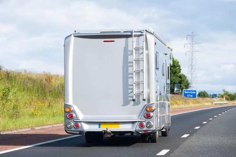 A camper van (motorhome) travelling south on the M6.