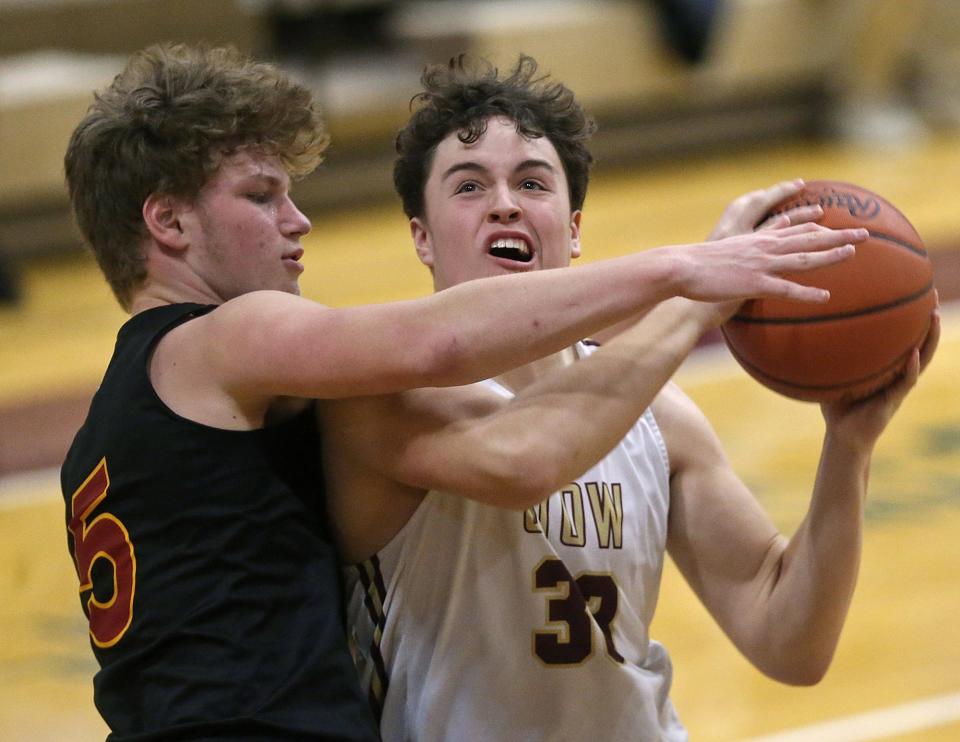 Stow's Nate Boozer, right, is fouled while shooting by Brecksville's Matt Rose during the second half of a basketball game on Tuesday in Stow.