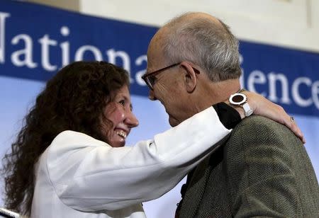 Dr. Gabriela Gonzalez, spokesperson for the LIGO Scientific Collaboration (L) embraces Dr. Rainer Weiss (R) of MIT at a news conference to discuss the detection of gravitational waves, ripples in space and time hypothesized by physicist Albert Einstein a century ago, in Washington February 11, 2016. REUTERS/Gary Cameron