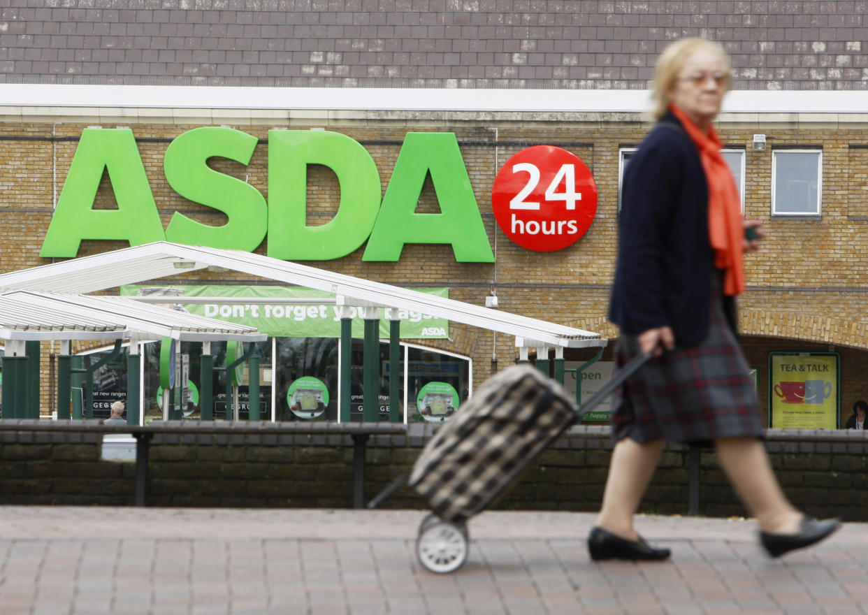 A shopper walks past an Asda superstore in south London. Photo: Luke MacGregor/Reuters