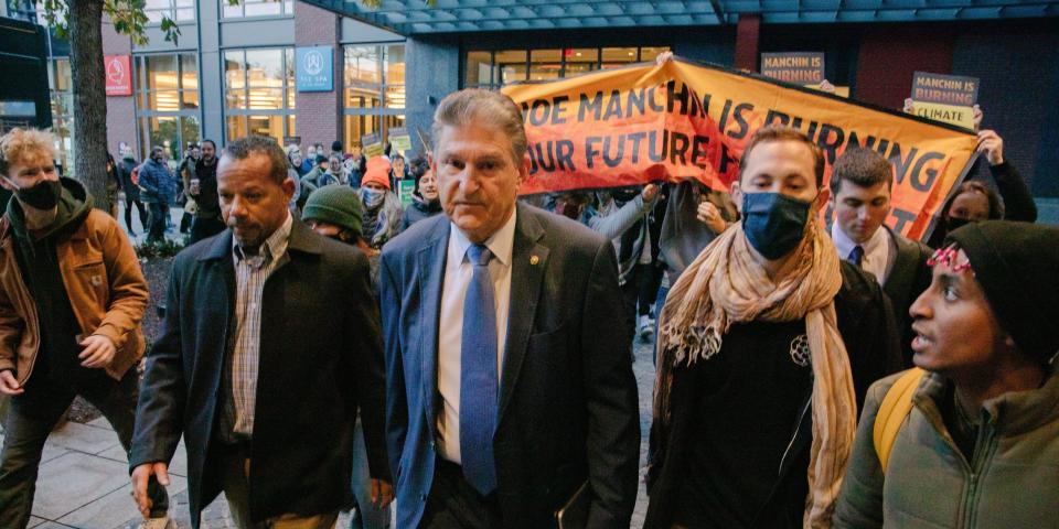 Climate change activists confront Sen. Joe Manchin, who has been one of two key holdouts on the reconciliation bill, which, in part, contains climate change solutions.