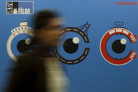 A woman walks past by a banner of Istanbul Film Festival at Atlas movie theatre in Istanbul April 14, 2015. REUTERS/Murad Sezer