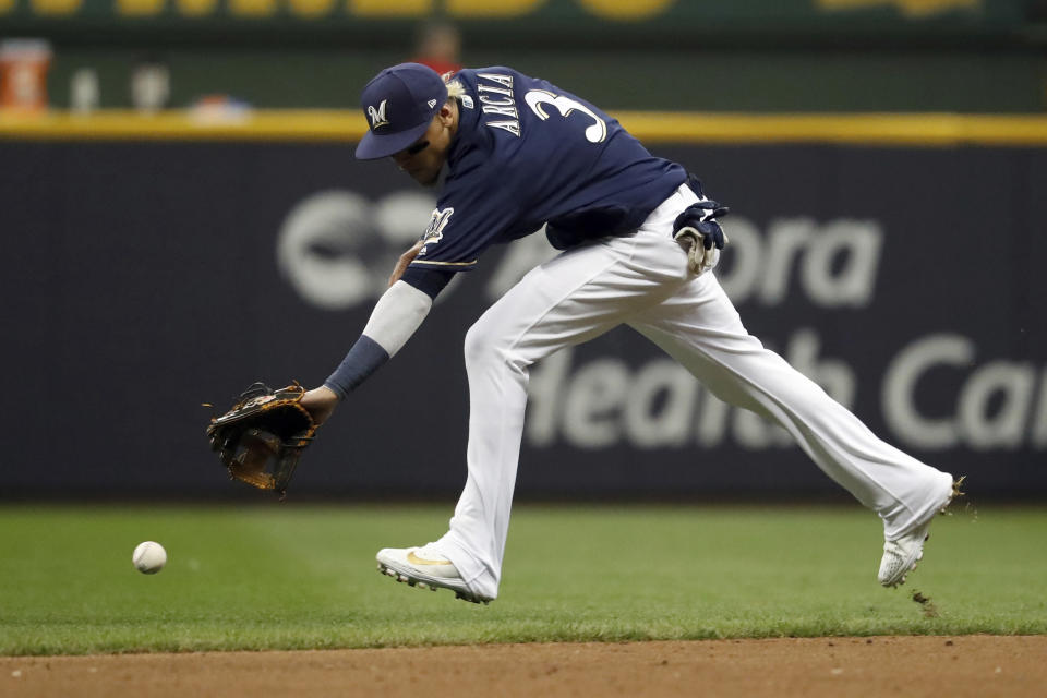 Milwaukee Brewers shortstop Orlando Arcia (3) is unable to reach the ball hit by Los Angeles Dodgers' Joc Pederson during the ninth inning of Game 2 of the National League Championship Series baseball game Saturday, Oct. 13, 2018, in Milwaukee. (AP Photo/Jeff Roberson)