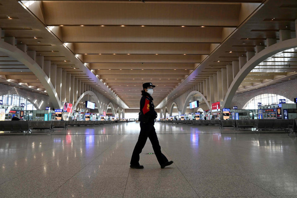 Image: A police patrol walking at an empty railway station as the city cuts outside transport links and bans residents from leaving, after the largest domestic Covid-19 coronavirus outbreak in six months in Shijiazhaung, in northern China's Hebei province (AFP - Getty Images)
