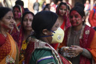 A reveller wearing a facemask amid fears of the spread of COVID-19 novel coronavirus, arrives to celebrate Holi, the spring festival of colours, on March 9, 2020. - Holi is observed at the end of the winter season on the last full moon of the lunar month. (Photo by PRAKASH MATHEMA / AFP) (Photo by PRAKASH MATHEMA/AFP via Getty Images)