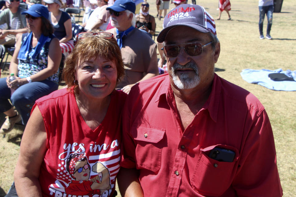 Deb Tulenchik and Galen Carlson of Pequot Lakes, Minn., attend a rally organized by pillow salesman-turned conspiracy theory peddler Mike Lindell in New Richmond, Wis., Saturday, June 12, 2021. Both were stunned by the election results and believe that former President Donald Trump really won. (AP Photo/Jill Colvin)