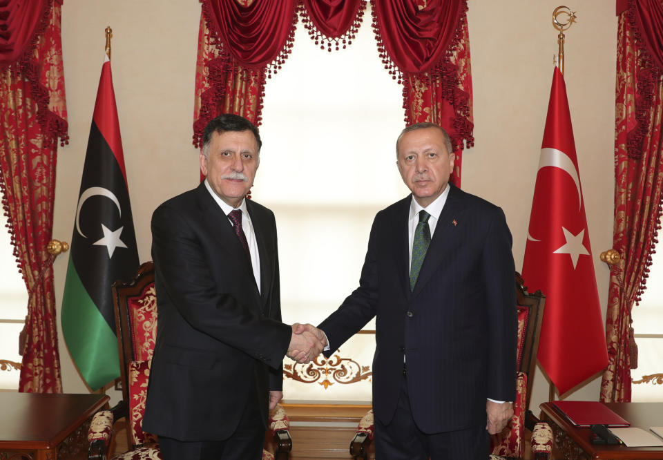 Turkey's President Recep Tayyip Erdogan, right, shakes hands with Fayez al Sarraj, the head of Libya's internationally-recognized government, prior to their meeting in Istanbul, Sunday, Jan. 12, 2020. The meeting at Dolmabahce Palace took place on the first day of a ceasefire in Libya initiated by Turkey and Russia. (Turkish Presidency via AP, Pool)