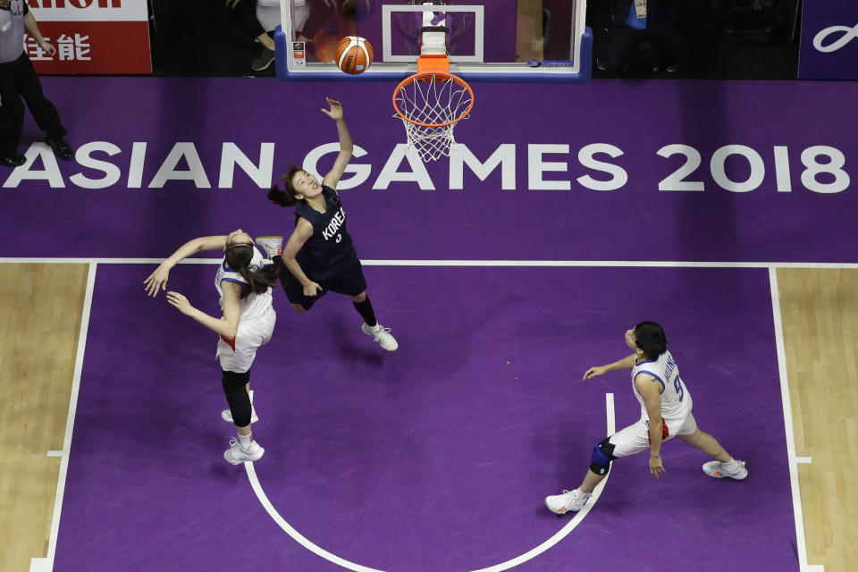 Combined Koreas Park Hyejin shoots the ball during their women's basketball match against Taiwan at the 18th Asian Games in Jakarta, Indonesia on Friday, Aug. 17, 2018. (AP Photo/Aaron Favila)