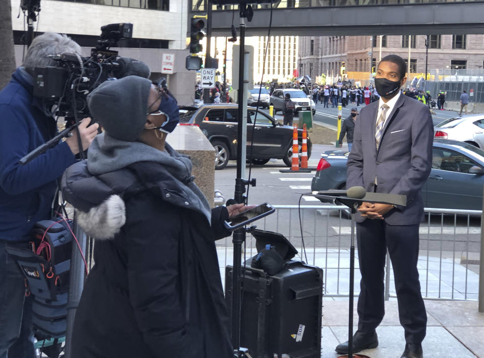 This image released by MSNBC shows Correspondent Shaquille Brewster, right, on location covering the the trial of former Minneapolis police officer Derek Chauvin in Minneapolis, Minn., on Wednesday April 7, 2021. Chauvin is charged with murder in the death of George Floyd during an arrest last May in Minneapolis. (MSNBC via AP)