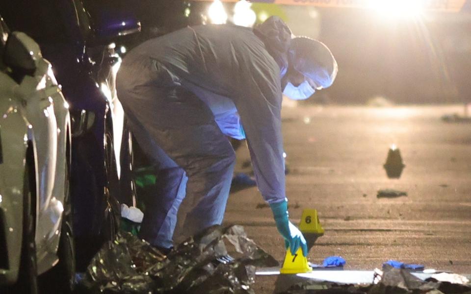 Forensic officers at a scene of a stabbing