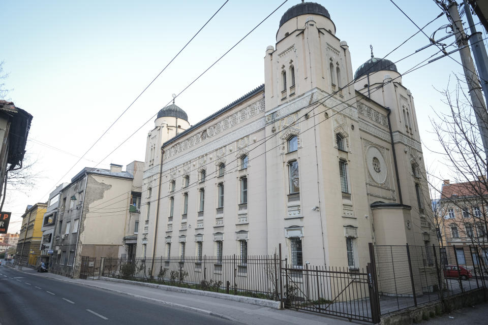 In this Friday, April 10, 2020 photo, the streets around the synagogue in Sarajevo, Bosnia, are deserted due to the national lockdown the authorities have imposed attempting to limit the spread of the new coronavirus. Traditionally, hundreds, sometimes thousands of residents who fled during the 1990s war and the years of economic instability that followed, return to Sarajevo each spring to celebrate religious or cultural holidays with family and friends. This year, nobody is returning leaving the streets and places for religious gatherings empty as families and friends celebrate the holidays apart due to the COVID-19 lockdown. (AP Photo/Kemal Softic)