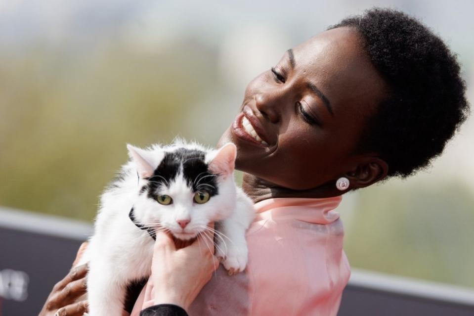 Kenyan actress Lupita Nyong'o poses with her cat Schnitzel at a photocall for the film A Quiet Place Day One.