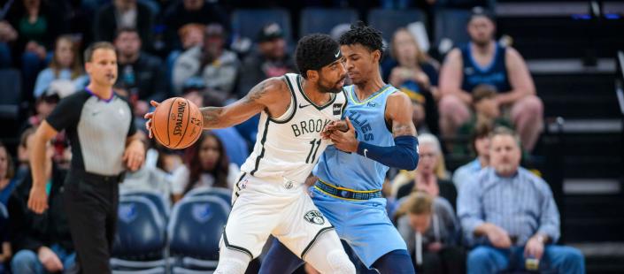 Oct 27, 2019; Memphis, TN, USA; Memphis Grizzlies guard Ja Morant (12) defends against Brooklyn Nets guard Kyrie Irving (11) during the first quarter at the FedExForum. Mandatory Credit: Jerome Miron-USA TODAY Sports