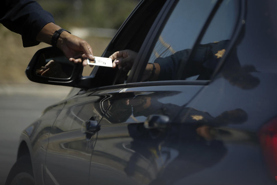 FILE - A California Highway Patrol officer stops a motorist who was suspected of speeding along Interstate 405 freeway on April 23, 2020, in Westminster, Calif. California law enforcement was more than twice as likely to use force against people they perceived as Black during vehicle and pedestrian stops in 2021, as compared to people believed to be white, according to a state report released Tuesday, Jan. 3, 2023. (AP Photo/Chris Carlson, File)