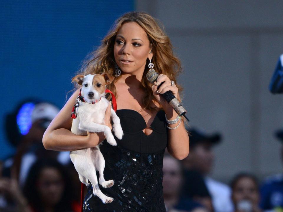 Mariah Carey performing with one of her dogs in 2012.