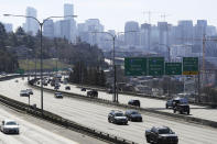 Early afternoon traffic is thin on Interstate 5 north of downtown Seattle, Friday, March 20, 2020. With many people working from home or otherwise not traveling, Seattle's notorious traffic has been minimal during the outbreak of the new coronavirus. (AP Photo/Ted S. Warren)