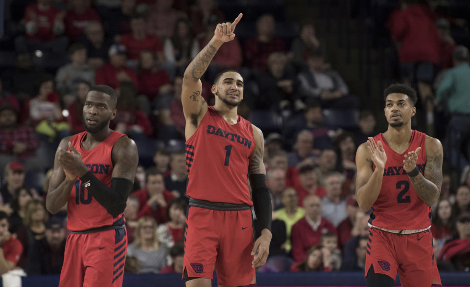 Dayton players ,Jalen Crutcher( 10), Obi Toppin (0) and Ibi Watson (2) celebrate after defeating Richmond in an NCAA college basketball game in Richmond, Va., Saturday, Jan. 25, 2020. (AP Photo/Lee Luther Jr.)