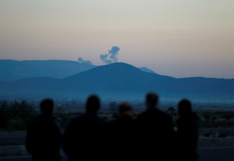 FILE PHOTO: Smoke rises from the Syria's Afrin region, as it is pictured from near the Turkish town of Hassa, on the Turkish-Syrian border in Hatay province, Turkey January 20, 2018. REUTERS/Osman Orsal/File Photo