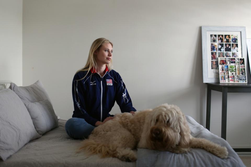 Hayley Hodson sits with her dog, Buddy, at her parents' Newport Beach home.