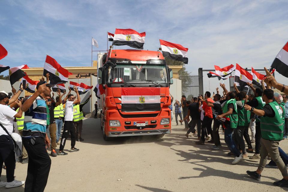 Egyptian aid workers celebrate as an aid truck crosses back into Egypt through the Rafah border crossing with the Gaza Strip on Oct. 21, 2023. T