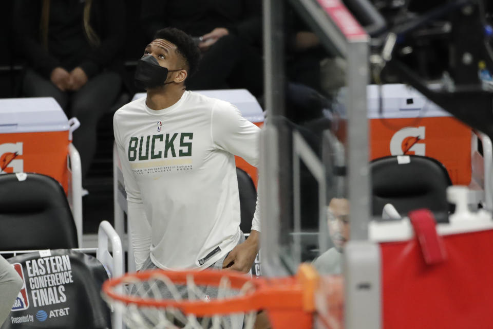 Milwaukee Bucks' Giannis Antetokounmpo looks up to the scoreboard from the bench during the second half of Game 5 of the team's NBA basketball playoffs Eastern Conference finals against the Atlanta Hawks on Thursday, July 1, 2021, in Milwaukee. (AP Photo/Aaron Gash)