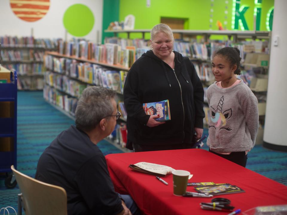 Though often a comedian, Chris Grabenstein describes to a student how it can often be an emotional experience to write a book.