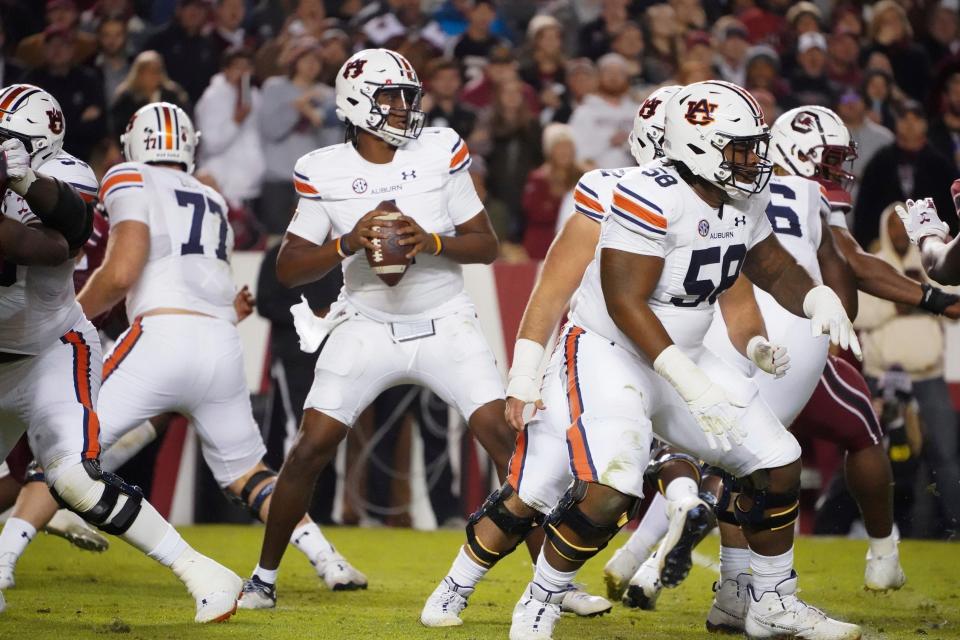 Auburn quarterback TJ Finley (1) looks for an open receiver during the first half of an NCAA college football game against South Carolina Saturday, Nov. 20, 2021, in Columbia, S.C. South Carolina won 21-17. (AP Photo/Sean Rayford)