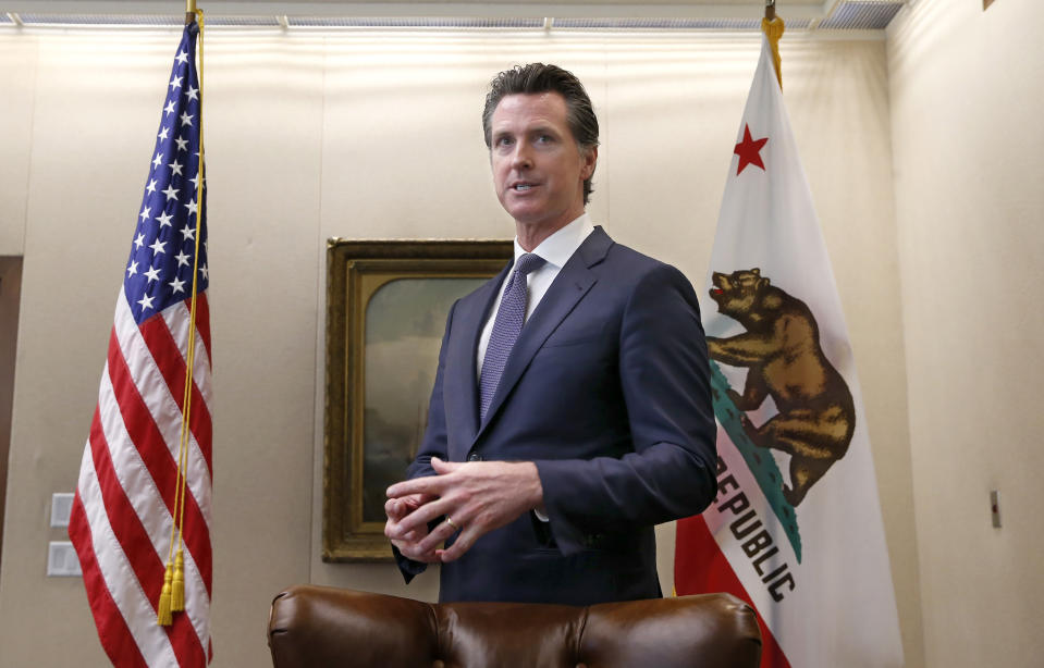 FILE - In this July 12, 2019, file photo, Gov. Gavin Newsom discusses his decision to fire state Oil and Gas Supervisor Ken Harris while talking with reporters at his office in Sacramento, Calif. Newsom said he fired Harris July 11 because he did not "exercise consistency" with the governor's opposition to hydraulic fracturing. Newsom on Saturday, Oct. 12, signed a law intended to counter Trump administration plans to increase oil and gas production on protected public land. (AP Photo/Rich Pedroncelli, File)