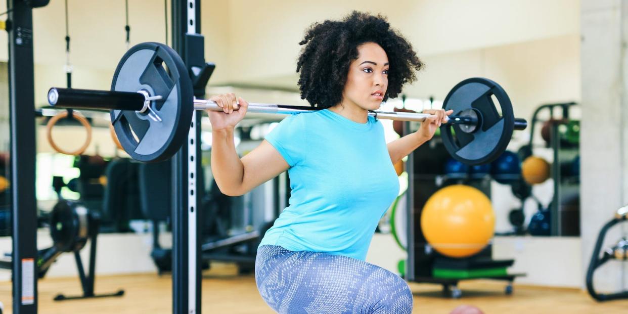 woman lifting weights working out