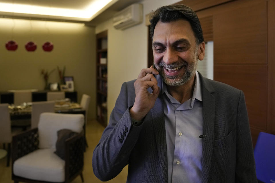 Ibrahim Mneimneh, a 46-year-old architect and one of 13 independent newcomers who won a seat in the latest parliamentary elections, smiles as he receives a congratulatory phone call at his home, in Beirut, Lebanon, Thursday, May 19, 2022. Broadly, they share a common stance that the decades-old grip on power by civil war-era warlords and sectarian-based political dynasties is the root cause behind rampant corruption, mismanagement, lack of services and lack of accountability that have driven the country into ruin. But the reform movement is fragmented and the challenges it faces in fighting an entrenched, sectarian-based ruling clique are enormous. (AP Photo/Hussein Malla)