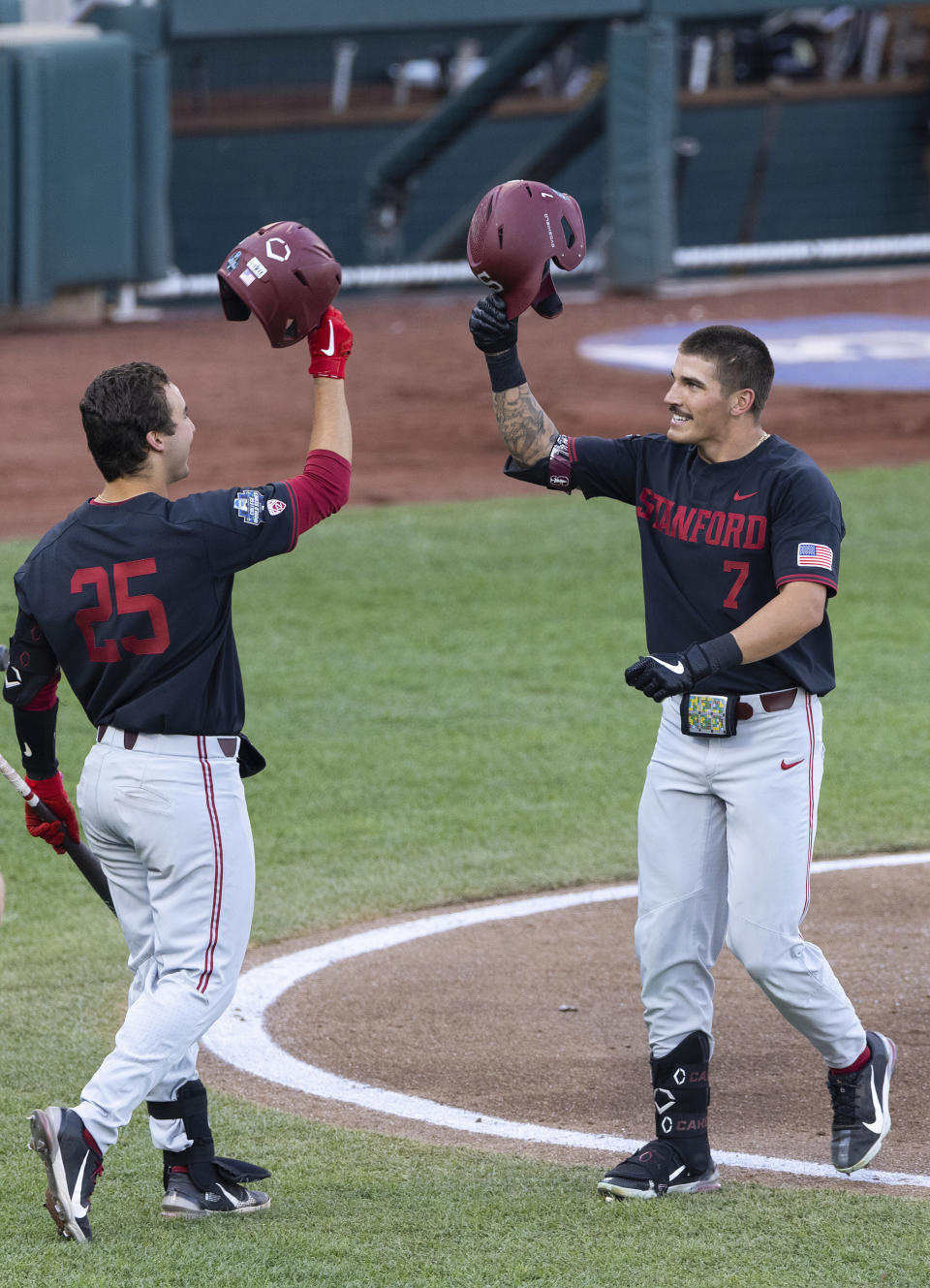 Stanford's Brock Jones (7), right, celebrates with Kody Huff (25) after hitting a home run in the third inning during a baseball game in the College World Series Wednesday, June 23, 2021, at TD Ameritrade Park in Omaha, Neb. (AP Photo/Rebecca S. Gratz)