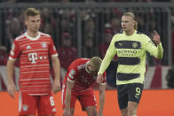 Manchester City's Erling Haaland, right, celebrates after scoring his side's opening goal during the Champions League quarter final second leg soccer match between Bayern Munich and Manchester City, at the Allianz Arena stadium in Munich, Germany, Wednesday, April 19, 2023. (AP Photo/Matthias Schrader)