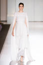 <p>Pleated tiers and a cape gives this wedding dress a Princess Leia twist. Is Meghan a <em>Star Wars</em> fan?</p>