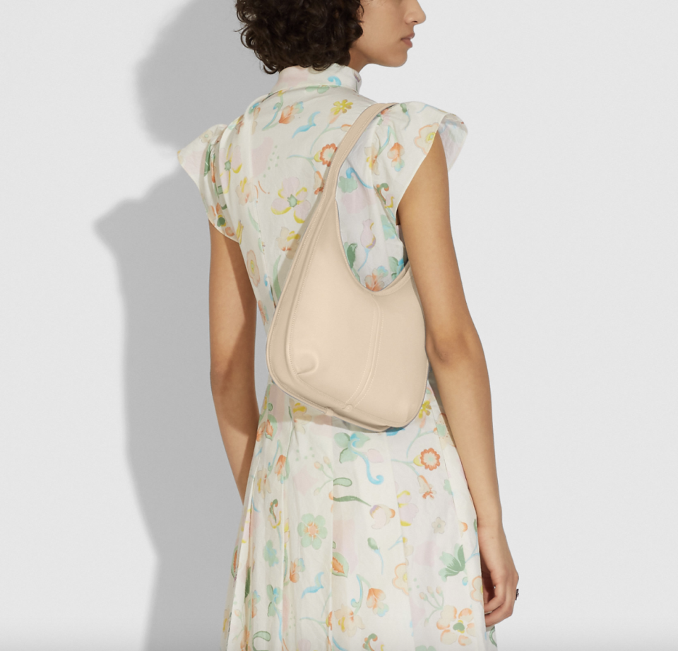 woman in white floral dress with coach Ergo Shoulder Bag in Ivory 