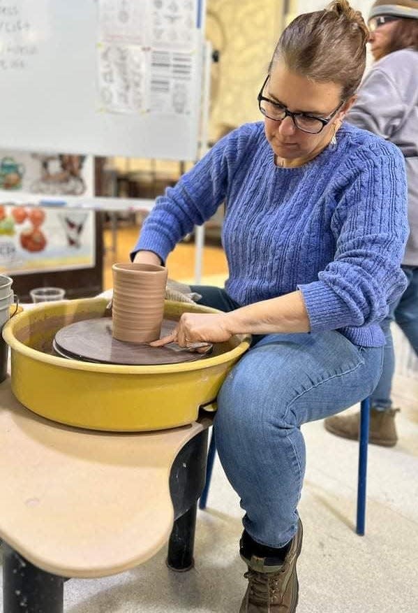 Betsy Brown works on ceramic piece. She fell in love with the art after her first wheel throwing class.