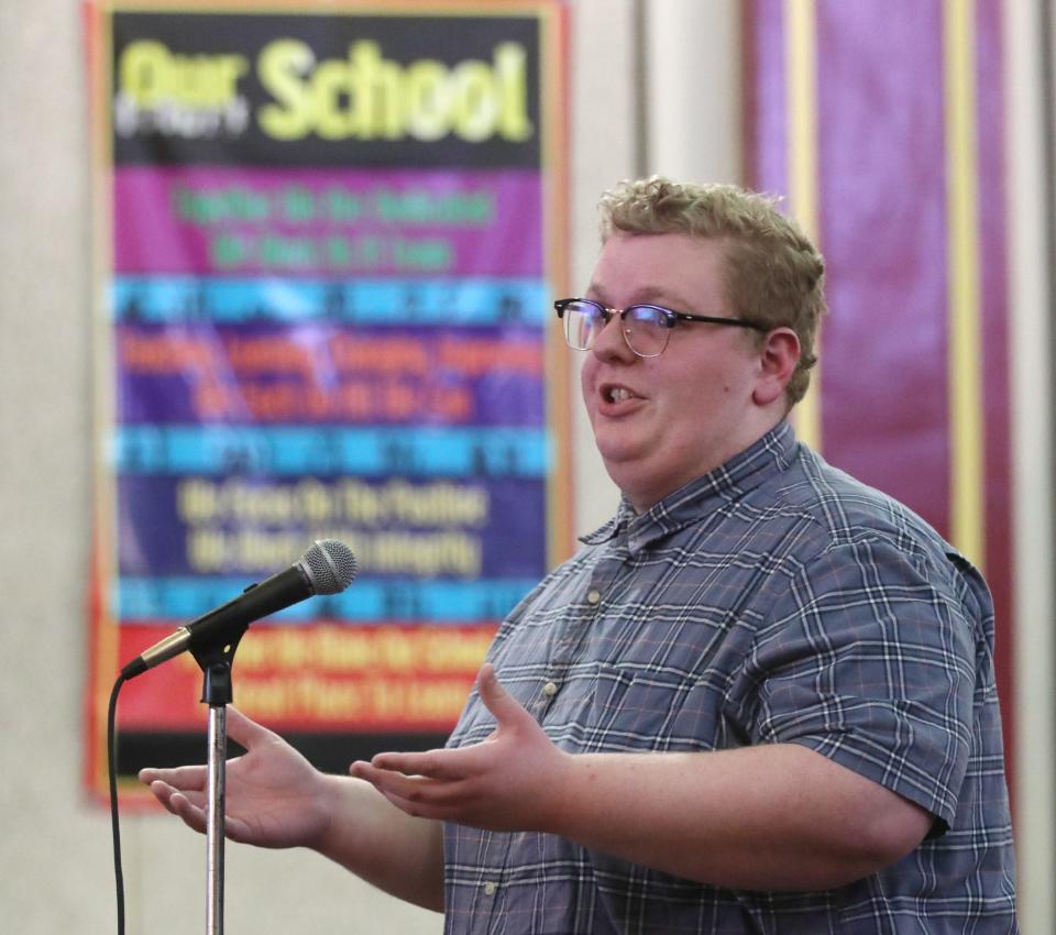 Aaron Uhl, a member of Progress through Preservation of Greater Akron, asks what are the plans for Firestone Elementary after it is closed during a proposed redistricting plan community meeting at Firestone Park Elementary School on Monday.