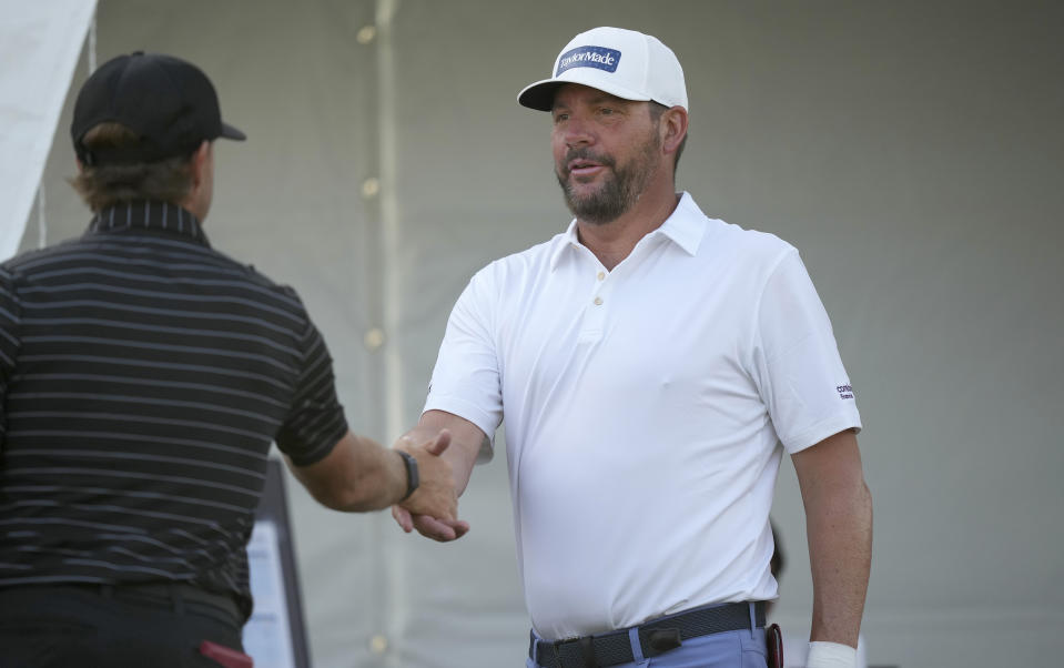 Michael Block shakes hands before his tee shot on the 10th hole during the second round of the Charles Schwab Challenge golf tournament at the Colonial Country Club in Fort Worth, Texas, Friday, May 26, 2023. (AP Photo/LM Otero)