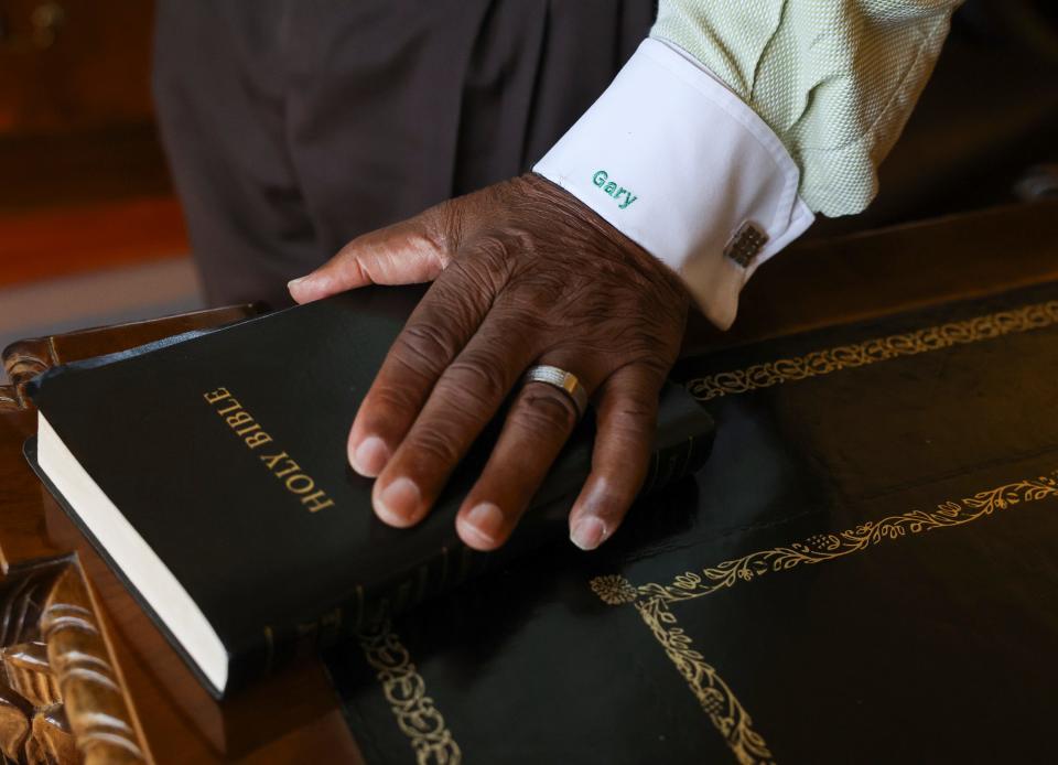 Lawyer Willie E. Gary's hand rests on a Bible in his Stuart office, the Waterside Professional Building, 221 W. Osceola Street, on Wednesday, Sept. 20, 2023.