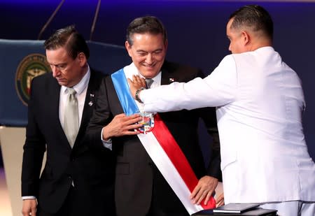 Panama's new President Laurentino Cortizo receives the presidential sash from the President of the National Assembly Marcos Castillero during his inauguration ceremony, in Panama City
