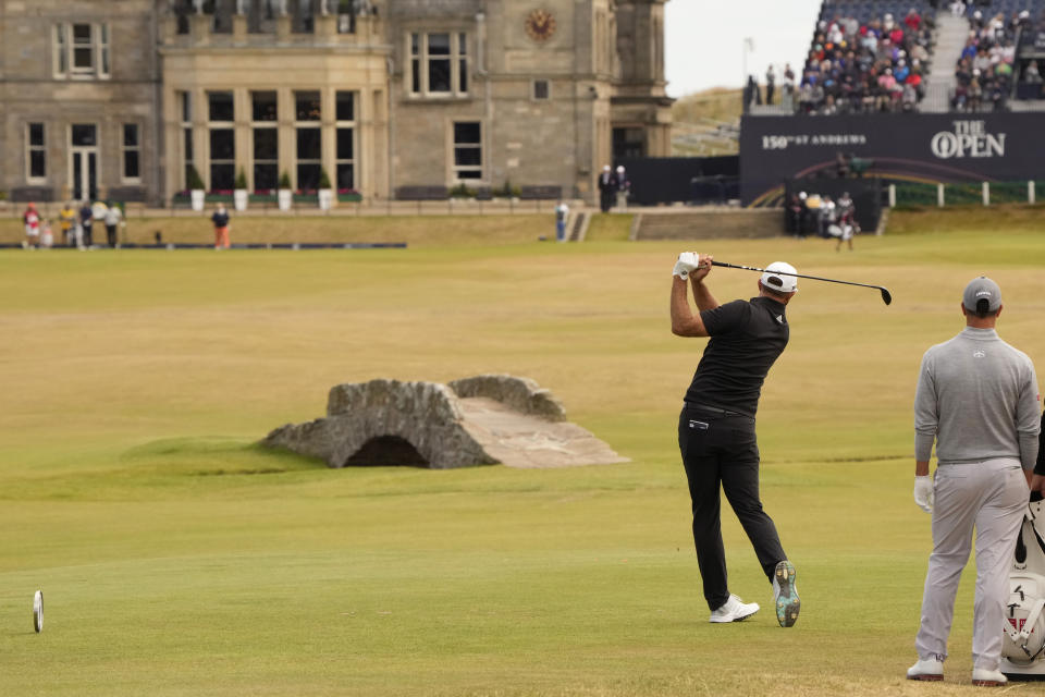 Dustin Johnson of the US plays from the 18th tee during the second round of the British Open golf championship on the Old Course at St. Andrews, Scotland, Friday July 15, 2022. The Open Championship returns to the home of golf on July 14-17, 2022, to celebrate the 150th edition of the sport's oldest championship, which dates to 1860 and was first played at St. Andrews in 1873. (AP Photo/Gerald Herbert)