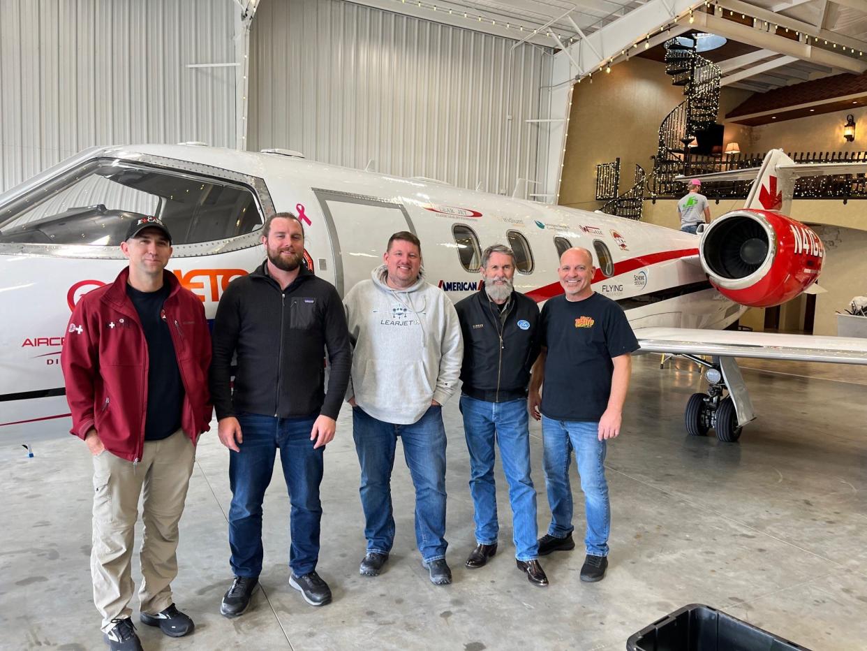 Madison Comprehensive High School 1995 graduate Bart Gray, 47, poses with the entire crew who plan to make an historic round-the-world flight in a Learjet 36A. Left to right are pilots Kirby Ezelle, Joshua Podlich, Gray, John Bone and Joel Weber.