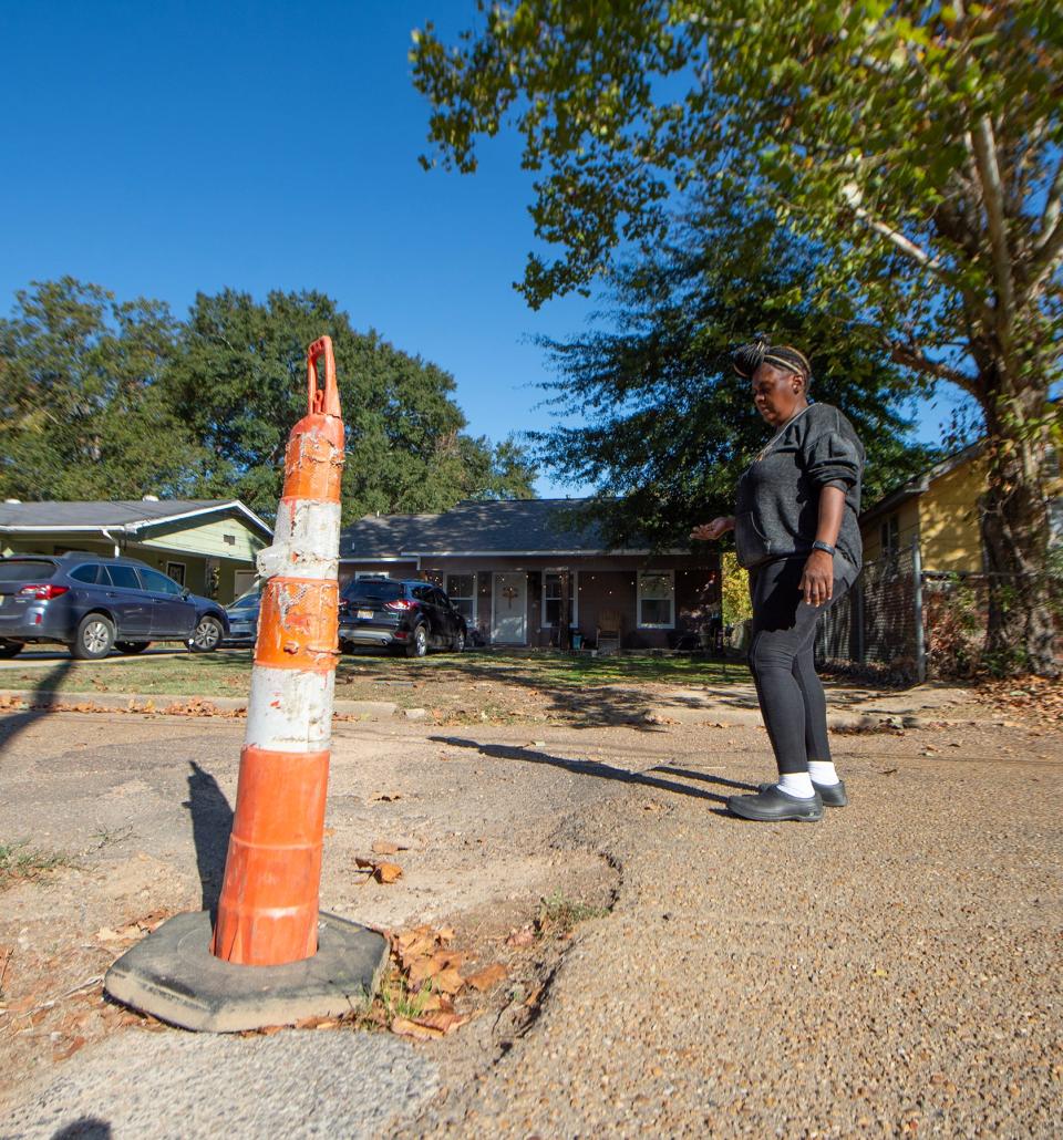 Yolanda R. Brinston, resident of Smith Robinson Street in Jackson, speaks about the years-long sewage issues on her street and the sinkhole that has formed in the blacktop in front of her house Tuesday, Oct. 24.